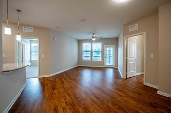 An empty living room with a hard wood floor
